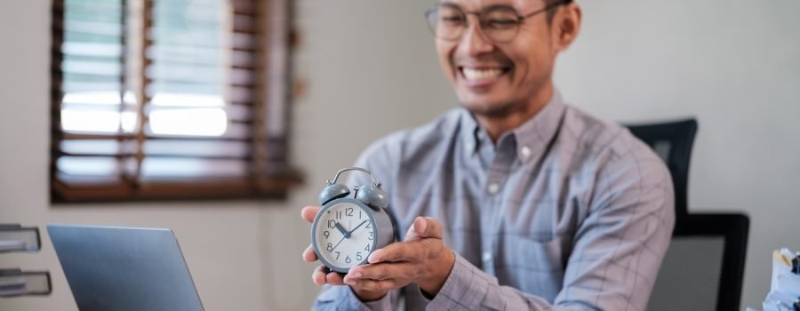 Young male employee in time management concept